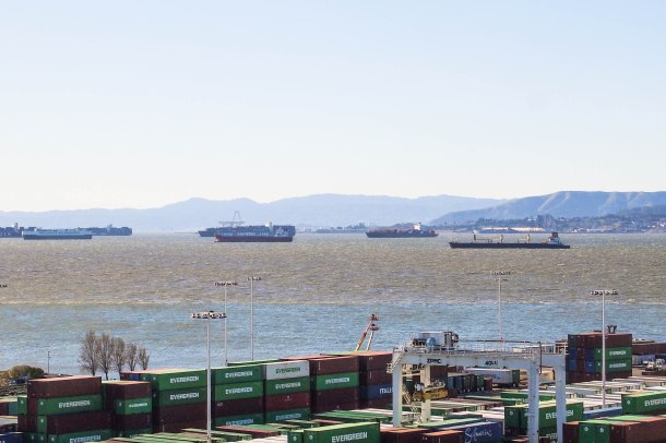 Scores of ships wait in an anchorage off the coast because the port of Oakland is at full capacity.